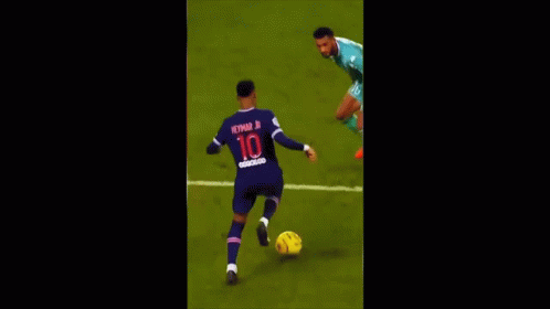 two players are chasing after a soccer ball on a field