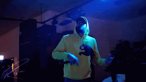 a person in a yellow hoodie is holding a knife