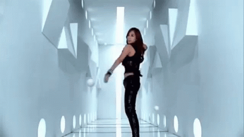 a woman in a futuristic sci - ficenty style hallway with lights on