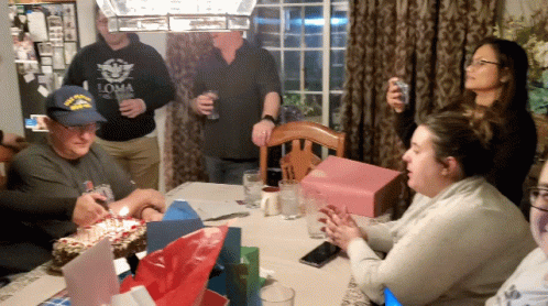 people sitting around the table in front of them having party