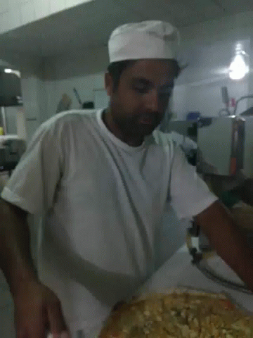 a man in a white shirt is kneading soing into a round bowl
