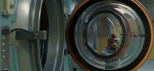 a man inside a washing machine in the bathroom
