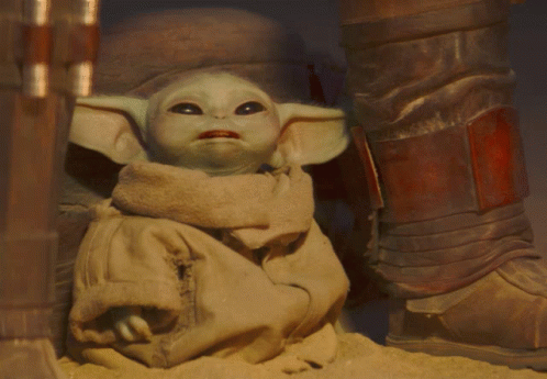 the baby yoda doll is in between two pairs of shoes