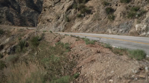 a car drives up a mountain with no tires