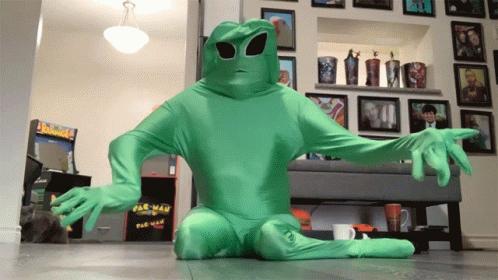 a man is dressed as an alien in a living room