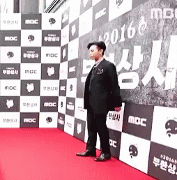 some men standing on purple carpet posing for the camera