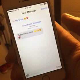 a hand holding an iphone with text message