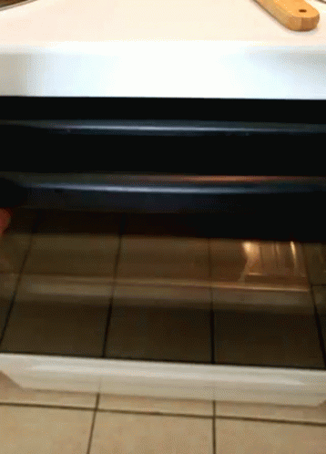 an oven door is open on a white table