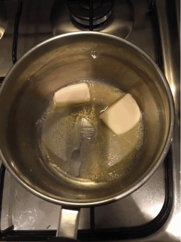 a pan with a block of ice floating in it