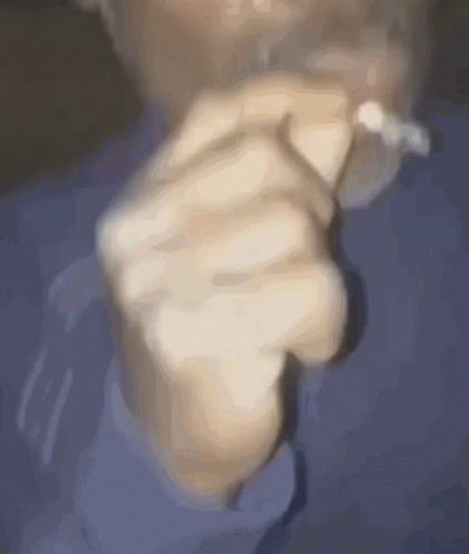 there is a blurry image of a person smoking a cigarette