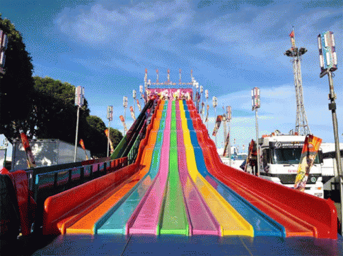 the rainbow slide is designed like a colorful boat
