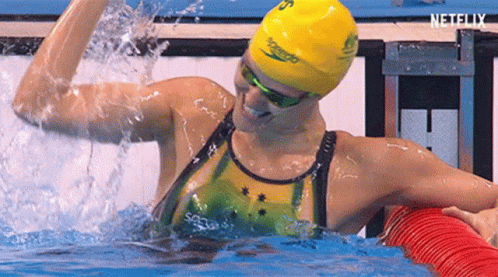 an olympic swimmer gets in the water to compete