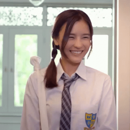 a girl with long hair wearing a tie and a school uniform