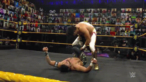 a person is wrestling another man on the floor