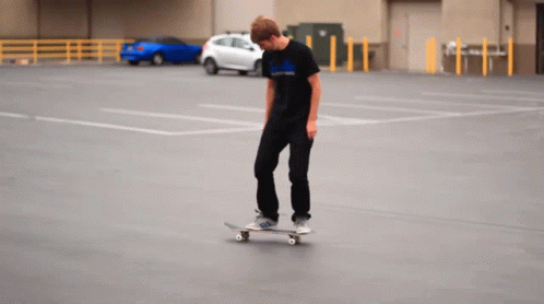 a person in a blue shirt is on a skateboard