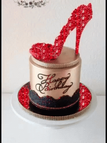 a cake has purple glitter on it as well as an elegant hat and heels