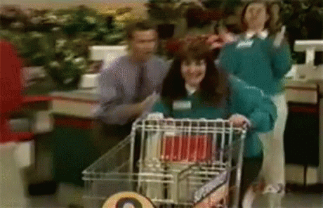 a couple of people standing around a shopping cart
