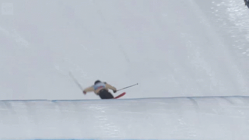 skier going up a hill on the side of an outdoor slope