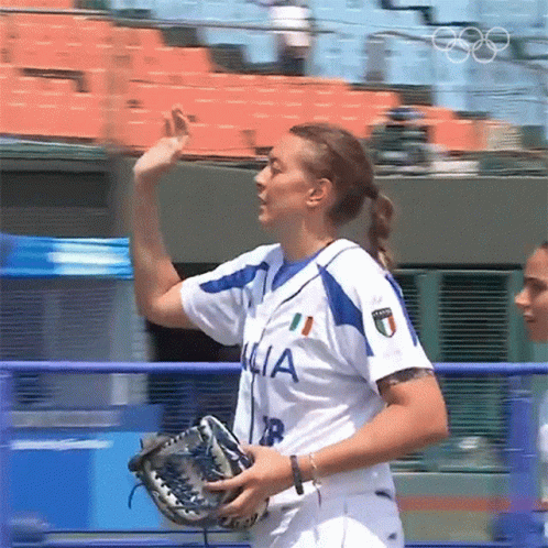 the female softball player waves in anticipation