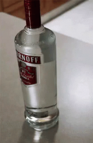 an empty bottle of gino off vodka sitting on a counter
