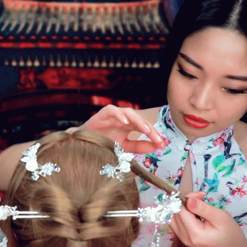 an oriental woman getting her hair done