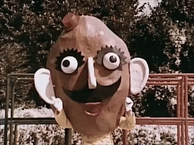 an animated head with eyes wearing a blue outfit