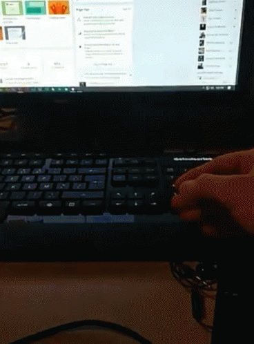 a person using a computer keyboard to use it