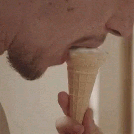 a man holding a large ice cream cone