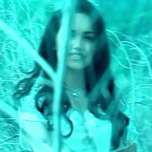 a woman is in the woods with long hair
