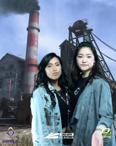 two asian girls in yellow jackets standing in front of a building