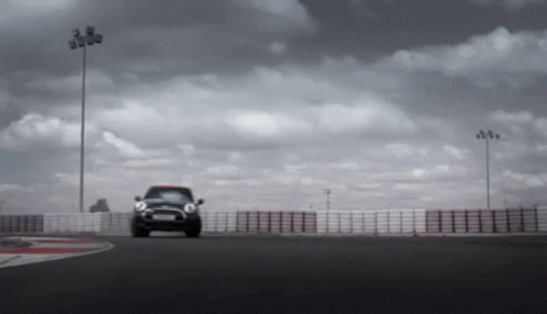 an automobile is driving in the middle of a track