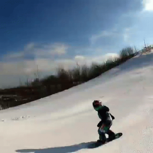 a guy on a snowboard going down a hill