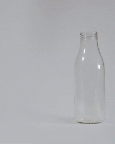 a clear glass jar on a white table
