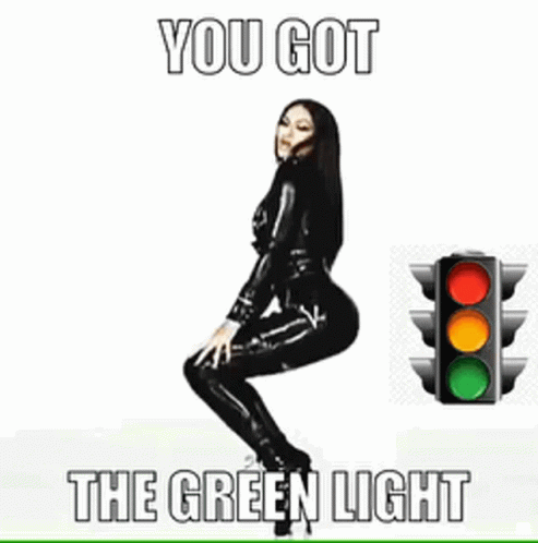 a poster with a woman in a latex suit next to a traffic light