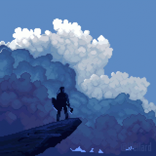 a man standing on top of a cliff on a mountain