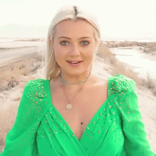 a woman with a blue make up and a green outfit