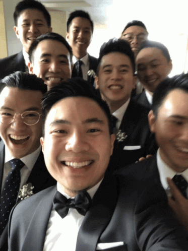 group of asian men in suits and ties are posing