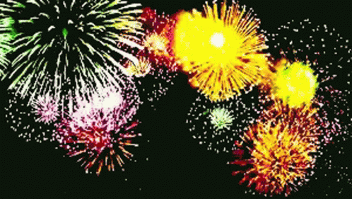 a blue and green fireworks with multiple colors