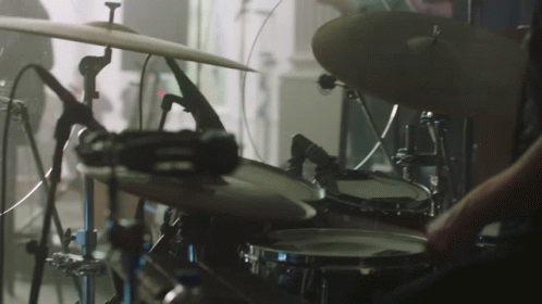 drums being played on stage in a music studio