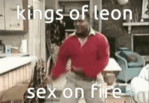 a man is standing in the kitchen with his shirt open and there is the caption, kings of leon sex on fire