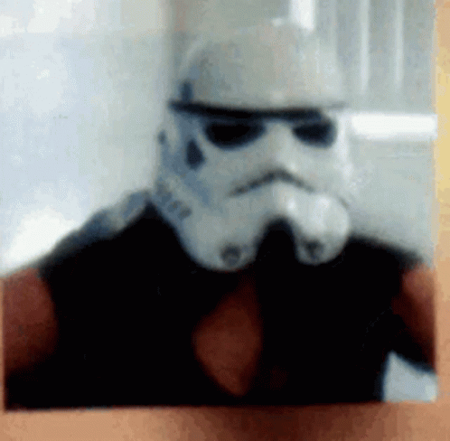 a person in a storm trooper helmet is wearing a star wars helmet