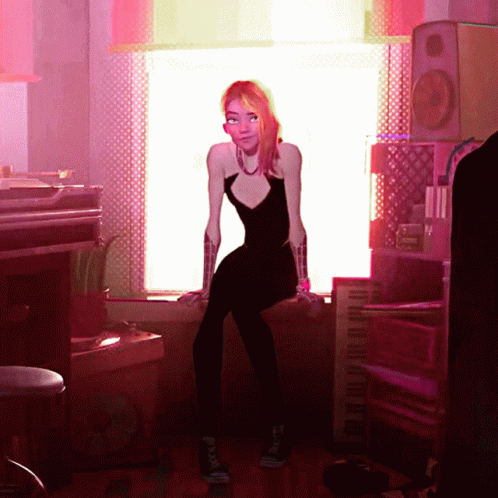 a female in a black dress standing next to a room