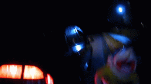 blurry image of a person wearing a helmet and holding lights
