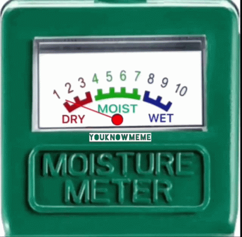 a green meter with the words moisture meter on it