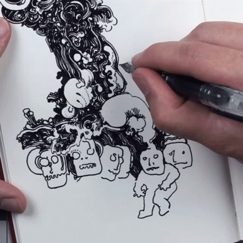 the artist draws sketches in his notebook to complete his drawings