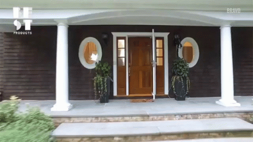 the front door to this home has arched columns