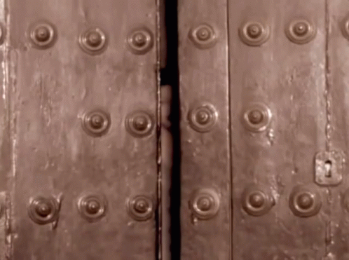 large metal doors with a bunch of round rivets