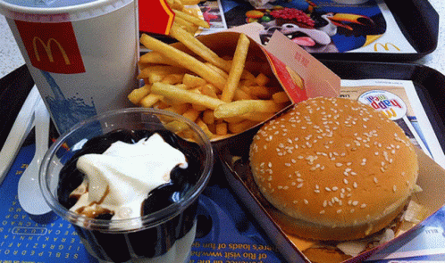 a tray with a tray and a soda, french fries, ice cream and hamburger