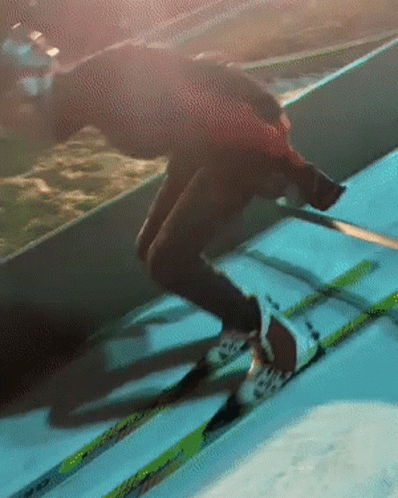 blurry po of person skiing in a skating rink