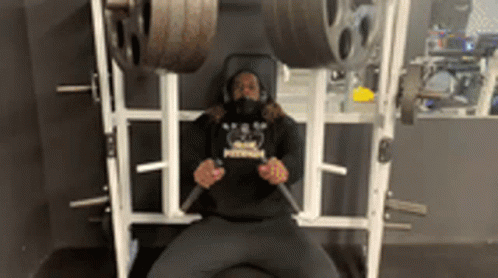 a person doing squats on a weight rack